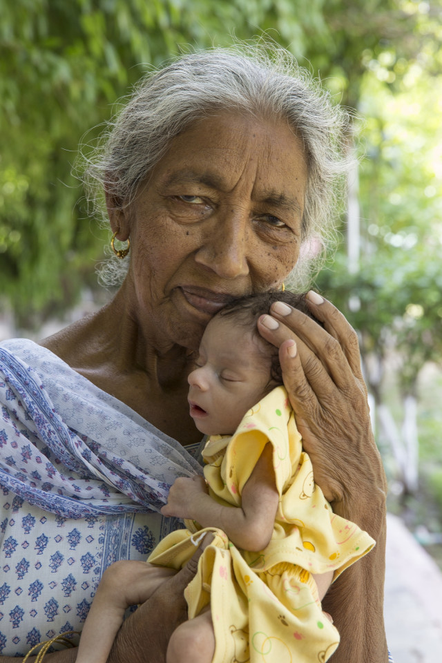 PUNJAB, INDIA - MAY, 26, 2016: Daljinder Kaur, 72, poses for a picture with her newly born baby boy, Arman Singh outside her residence in Amritsar city of Punjab, India. Daljinder Kaur, 72, suffered three miscarriages after her marriage in September 1970 finally gave a birth to a healthy baby boy through In Vitro Fertilization (IVF) treatment at National Fertility and Test Tube Baby Center in Hisar district of Haryana, India on April 19, 2016. The baby weighing 2kg was produced after 37 weeks of pregnancy with the help of donor sperms and eggs that were used for fertilization. Both mother and son are in a healthy state. Photography by: Cover Asia Press / Faisal Magray